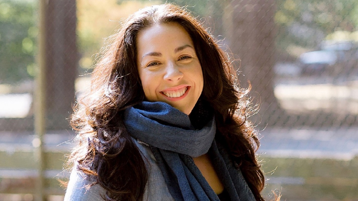 woman with long brown hair, smiling