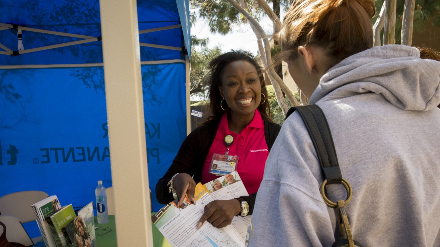 A Kaiser Permanente employee talks with a prospective member